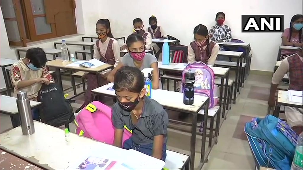 Students sit in classroom at Govt Girls' Senior Secondary School in Amritsar as schools open in Punjab after over a year, with relaxations in #COVID19 restrictions.