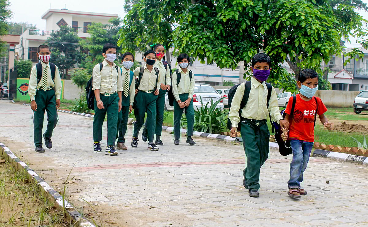 Children walk towards their school after ease in COVID-induced restrictions, in Patiala, Punjab on Monday, August 2, 2021.