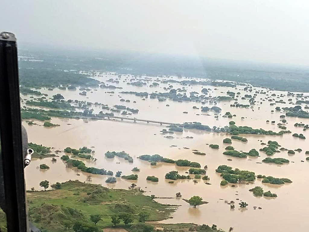 Uttar Pradesh, Aug 10 (ANI): An ariel view of a partially submerged land in floodwater, in Jalaun on Tuesday.