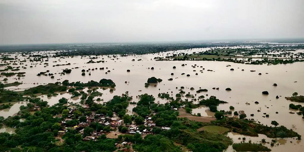 Uttar Pradesh, Aug 10 (ANI): An ariel view of a partially submerged land in floodwater, in Jalaun on Tuesday.