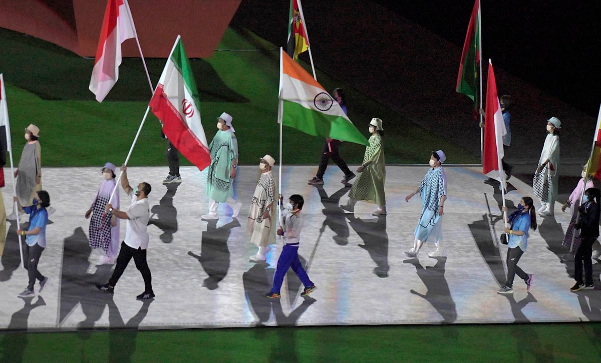 Gold medalist Neeraj Chopra holds the Indian flag at the Olympics Stadium during the closing ceremony of the Summer Olympics 2020, in Tokyo, Japan, Sunday, Aug. 8, 2021.