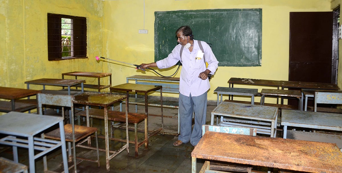 SPRAYING AWAY THE VIRUS: Sanitization worker sprays sanitizers in the classrooms before the children return to their desks after long wait.