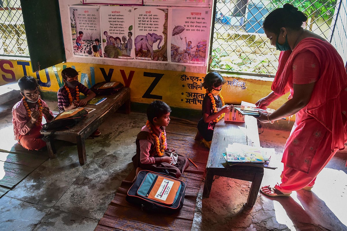 Students attend a class at a school in Allahabad on September 1, 2021 after a long interval of months as the state government relaxed the Covid-19 coronavirus lockdown norms for educational institutions, allowing students from 1st-5th standard to attend physical classes with 50 percent capacity.