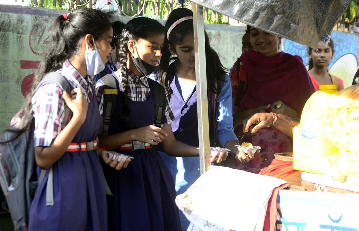 Girls enjoy Pani Puris outside their schools on Wednesday after their classes get dismissed.