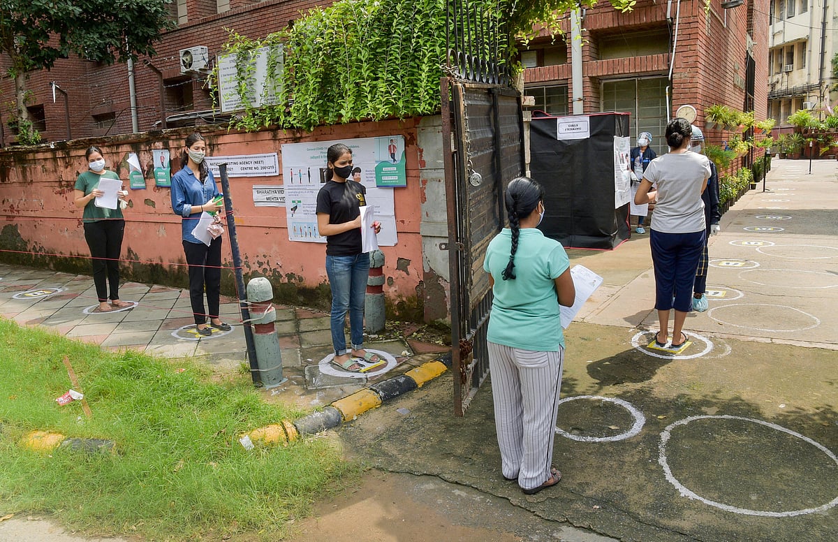 New Delhi: Aspirants of medical entrance examination of National Eligibility cum Entrance Test (NEET) queue outside an examination centre following COVID protocol in New Delhi, Sunday, Sept. 12, 2021.