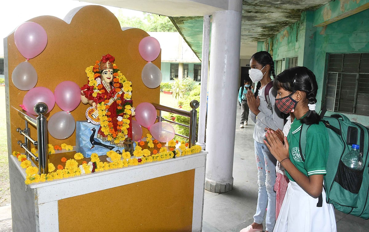 SHOWERS OF BLESSINGS: Students take blessings from Goddess Saraswati before attending their first physical class in a long time.
