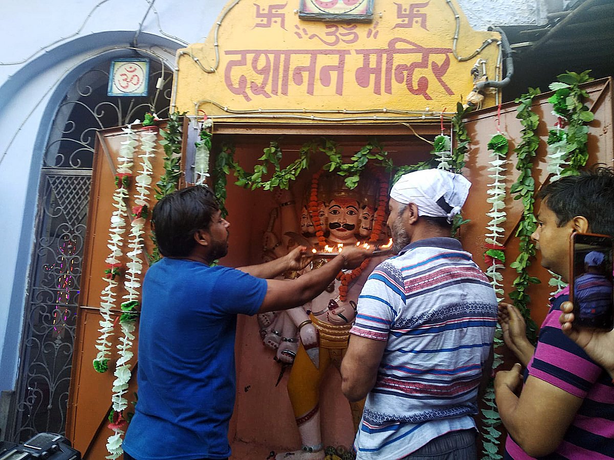 People worship at the Dashanan Mandir on the occasion of Dussehra, in Kanpur on Friday.