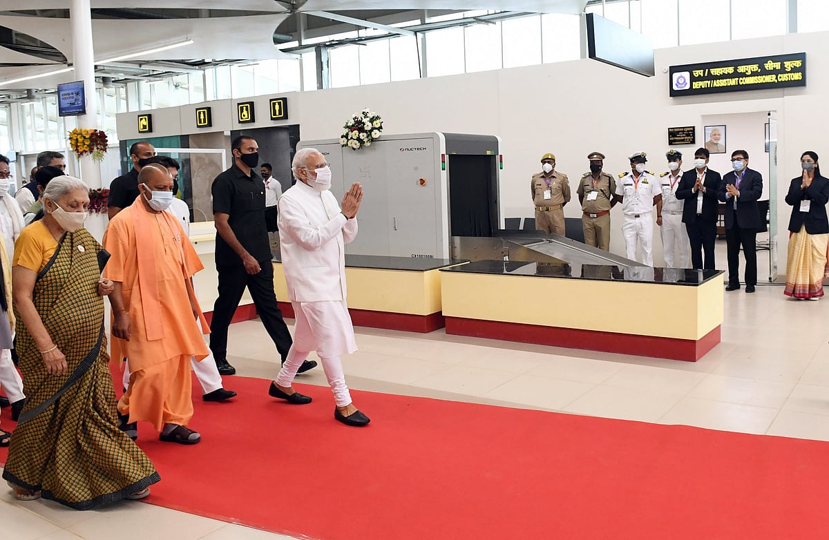 Prime Minister Narendra Modi arrives at Kushinagar International Airport, in Kushinagar on Wednesday. Uttar Pradesh Chief Minister Yogi Adityanath, Governor Anandiben Patel and other dignitaries are also seen. 