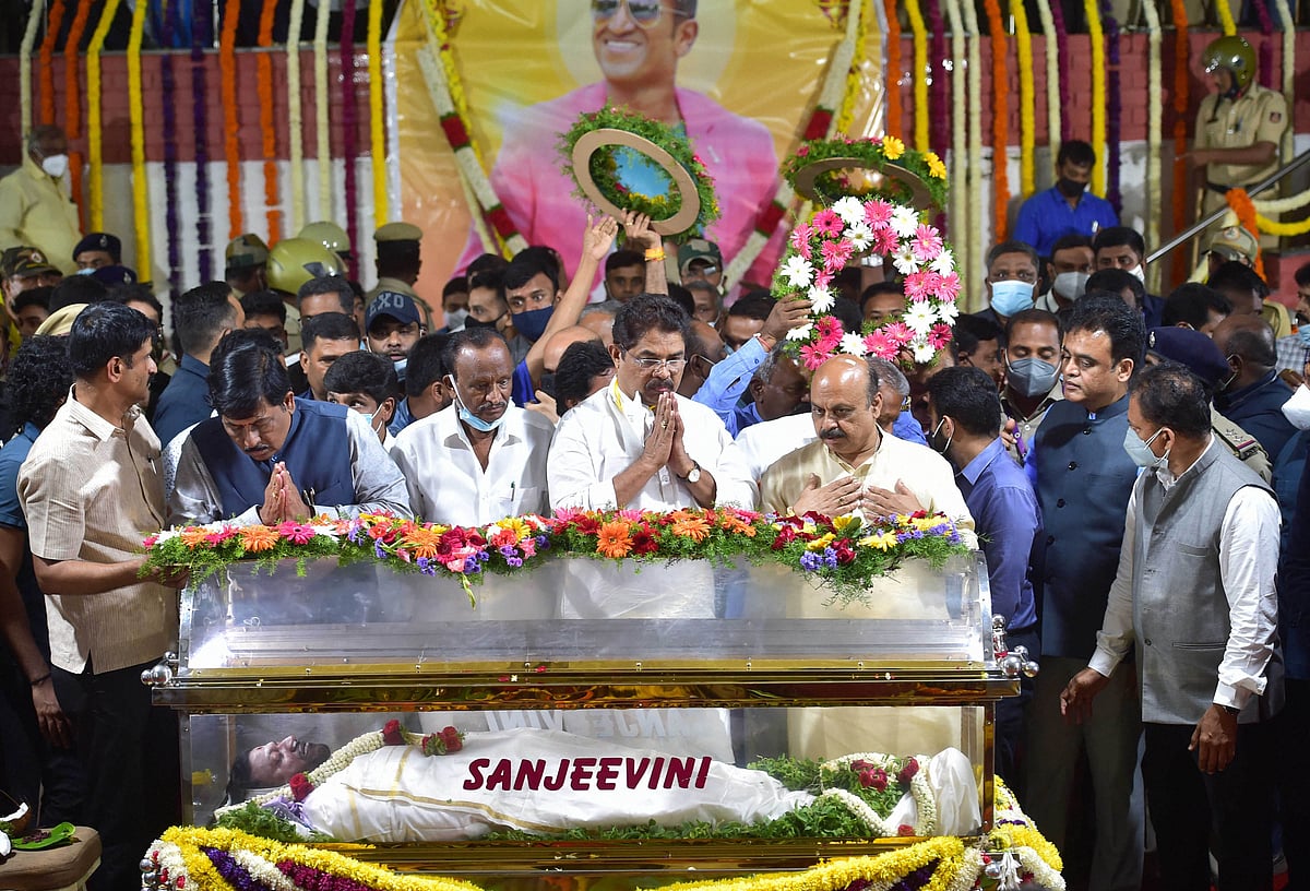 Bengaluru: Karnataka Chief Minister Basavaraj Bommai and others pay their last respects to the mortal remains of Kannada film actor Puneeth Rajkumar at the Kanteerava Stadium, in Bengaluru, Friday, Oct. 29, 2021. Rajkumar passed away due to a fatal cardiac arrest on Friday morning.