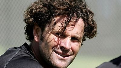 Former New Zealand all-rounder Chris Cairns plays cricket on wheelchair