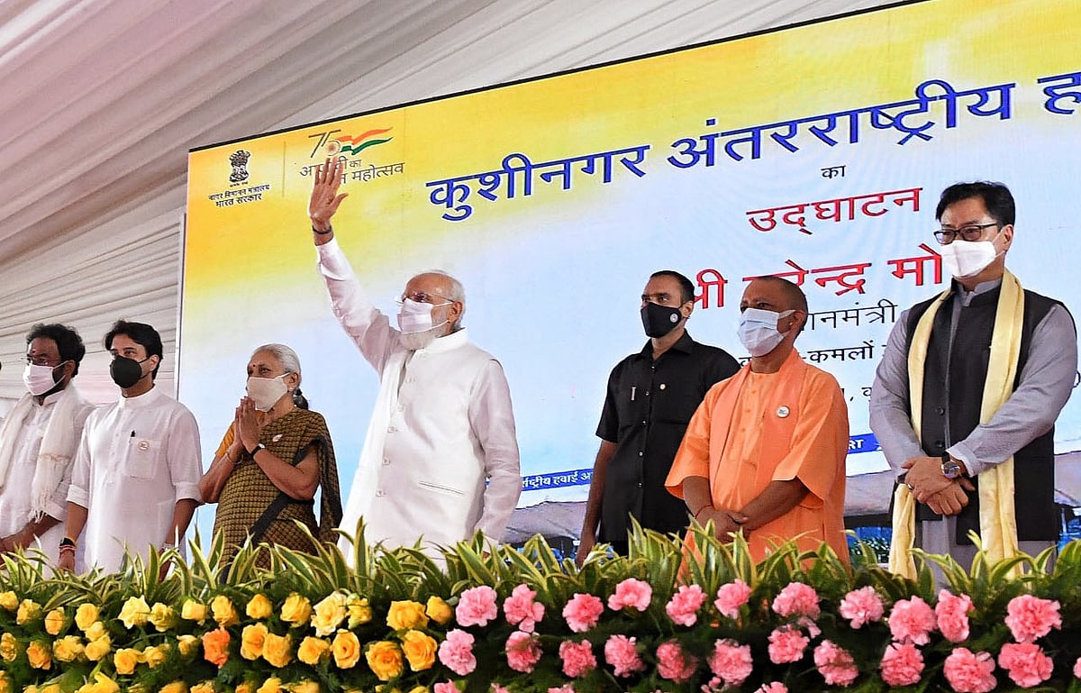 Prime Minister Narendra Modi waves his hand at the inauguration of the Kushinagar International Airport, in Kushinagar on Wednesday. Uttar Pradesh CM Yogi Adityanath, Governor Anandiben Patel and other dignitaries are also seen.