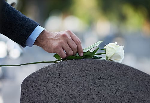 Instagram model slammed for posing for photos at her veteran father's funeral in front of his open casket