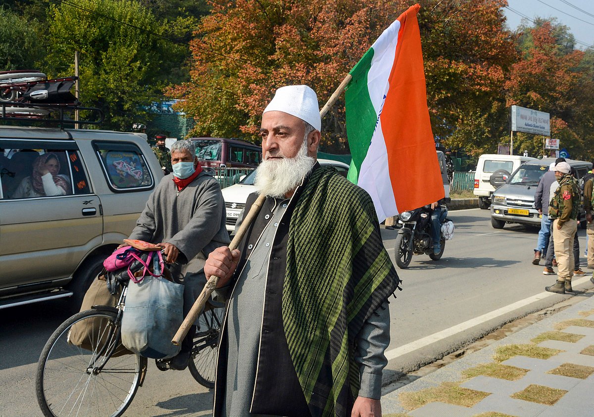 A Bharatiya Janata Party (BJP) worker holds the tricolour during Run For Unity Rashtriya Ekta Diwas on the birth anniversary of Sardar Vallabh Bhai Patel, on the banks of Dal Lake in Srinagar, Sunday, Oct. 31, 2021.