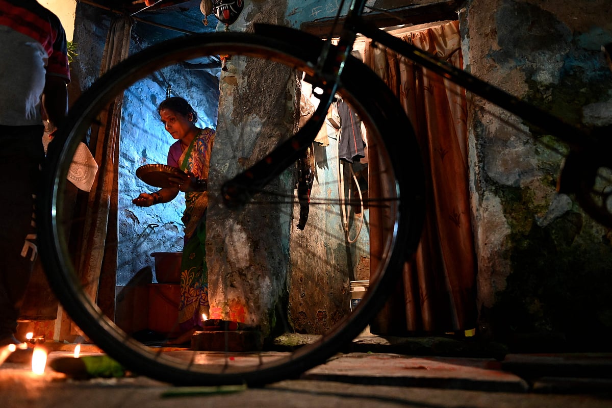 Hindu devotees perform Ayudha Puja ritual (worship of instruments) on their bicycle on the occasion of Dussehra-Vijay Dashami festival in New Delhi on October 14, 2021.