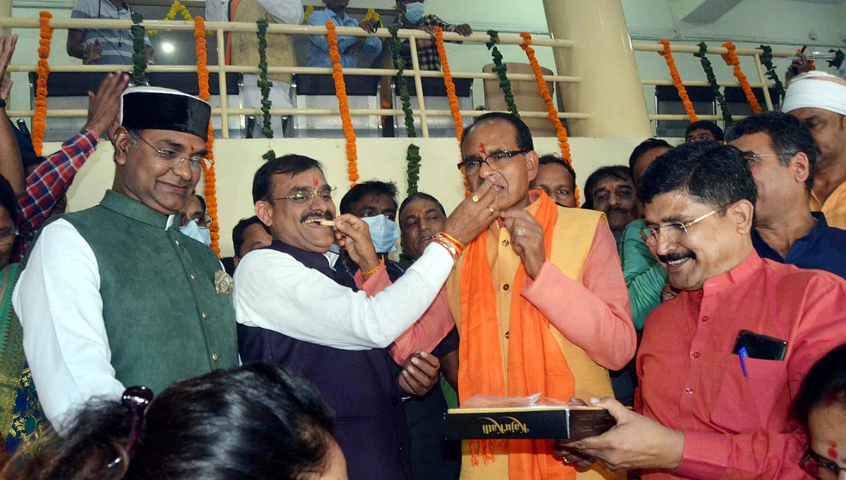 Madhya Pradesh Chief Minister Shivraj Singh along with BJP State President VD Sharma celebrate as party leading in State by-polls, at BJP State headquarters in Bhopal, Tuesday