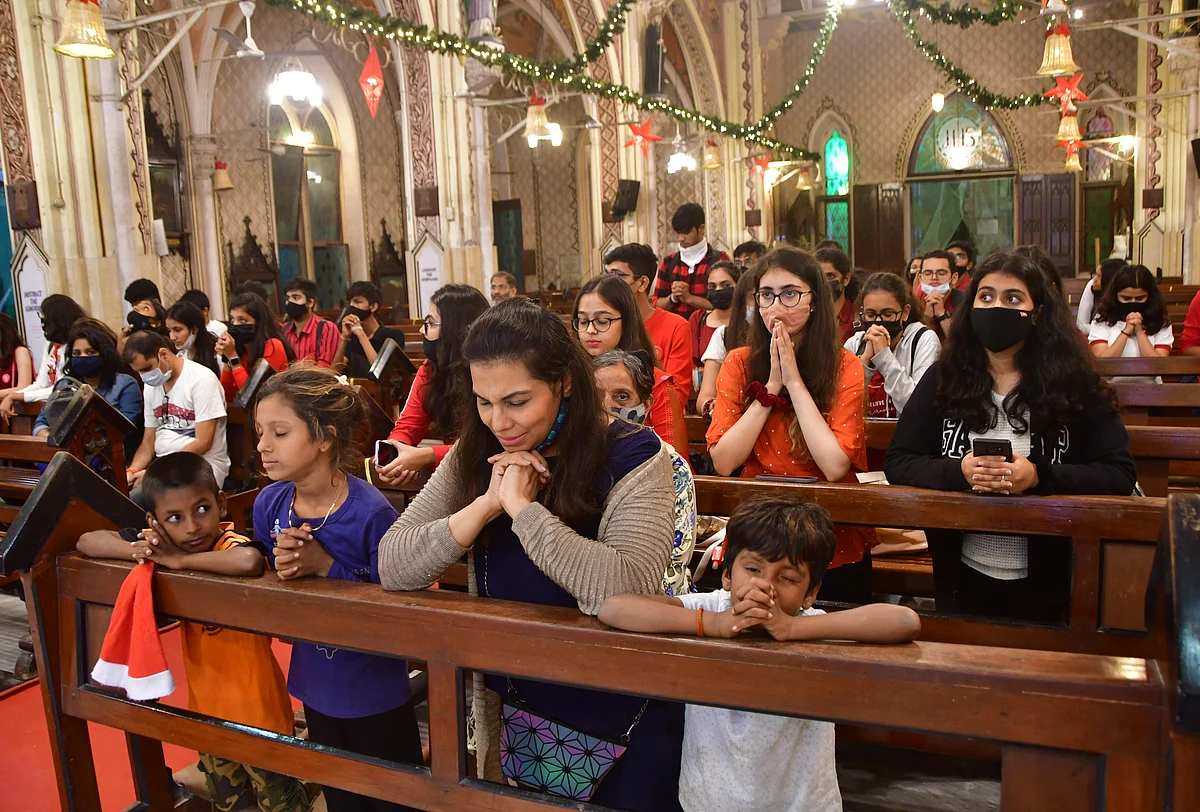 Mumbai: Devotees pray at Holy Name Cathedral church, in Mumbai, Friday, Dec. 24, 2021.