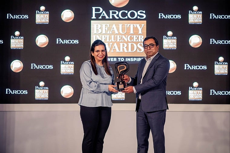 Villoo Daji and Biju Antony revealing the trophy for the award