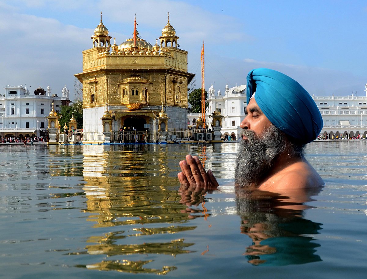 Amritsar: A devotee takes a dip in the holy sarovar (pond) on the occasion of the birth anniversary of the 10th Sikh Guru Gobind Singh, at the Golden Temple in Amritsar, Sunday, January 9, 2022.