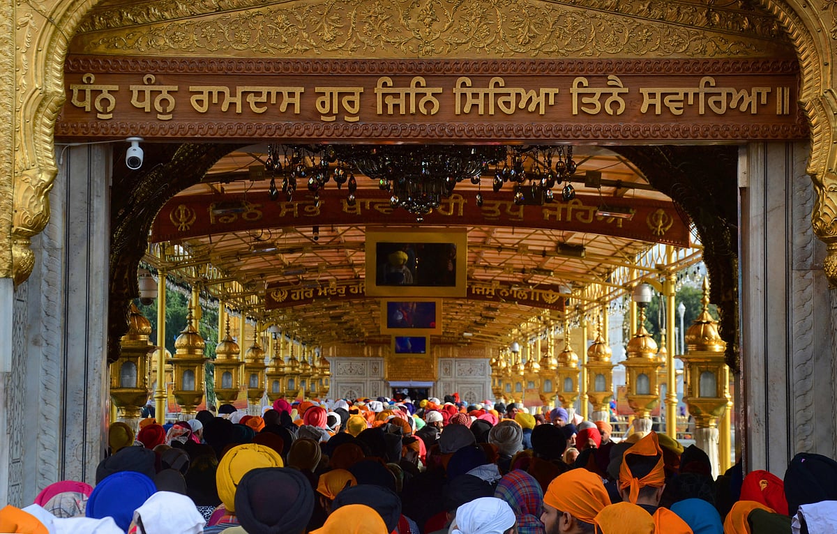 Amritsar: Devotees gather to pay respects on the occasion of the birth anniversary of the 10th Sikh Guru Gobind Singh, at the Golden Temple in Amritsar, Sunday, January 9, 2022.