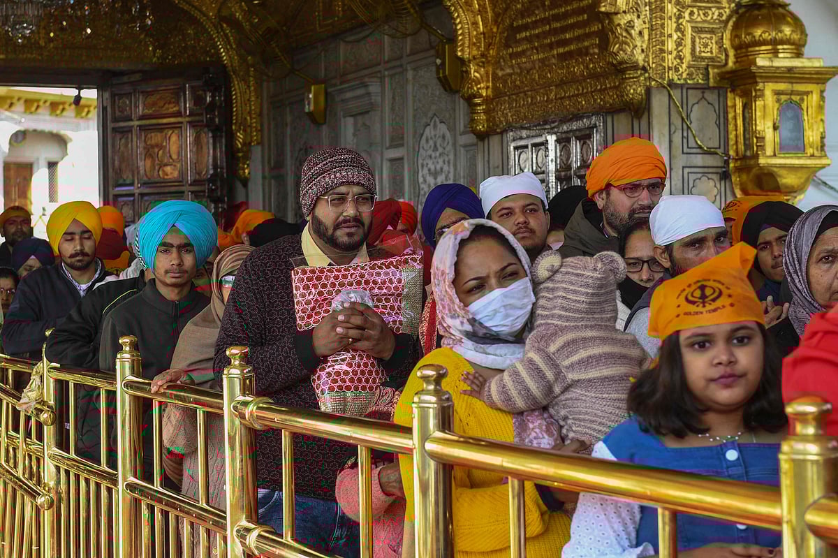 Sikh devotees gather to pay respect on the occasion of the birth anniversary of the 10th Sikh Guru Gobind Singh at the Golden Temple in Amritsar on January 9, 2022.