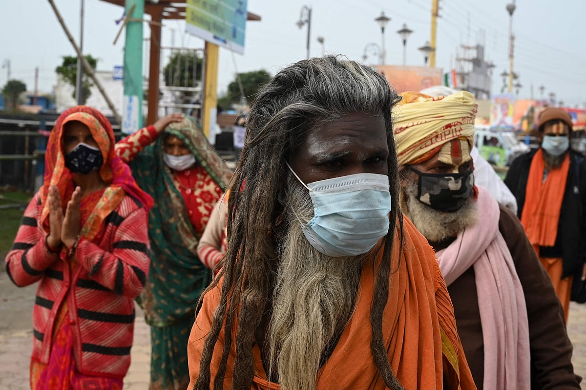 Pilgrims arrive to offer prayers at a temple during the Hindu religious festival of Gangasagar Mela on Sagar Island, some 150 km south of Kolkata, West Bengal, on January 13, 2022.