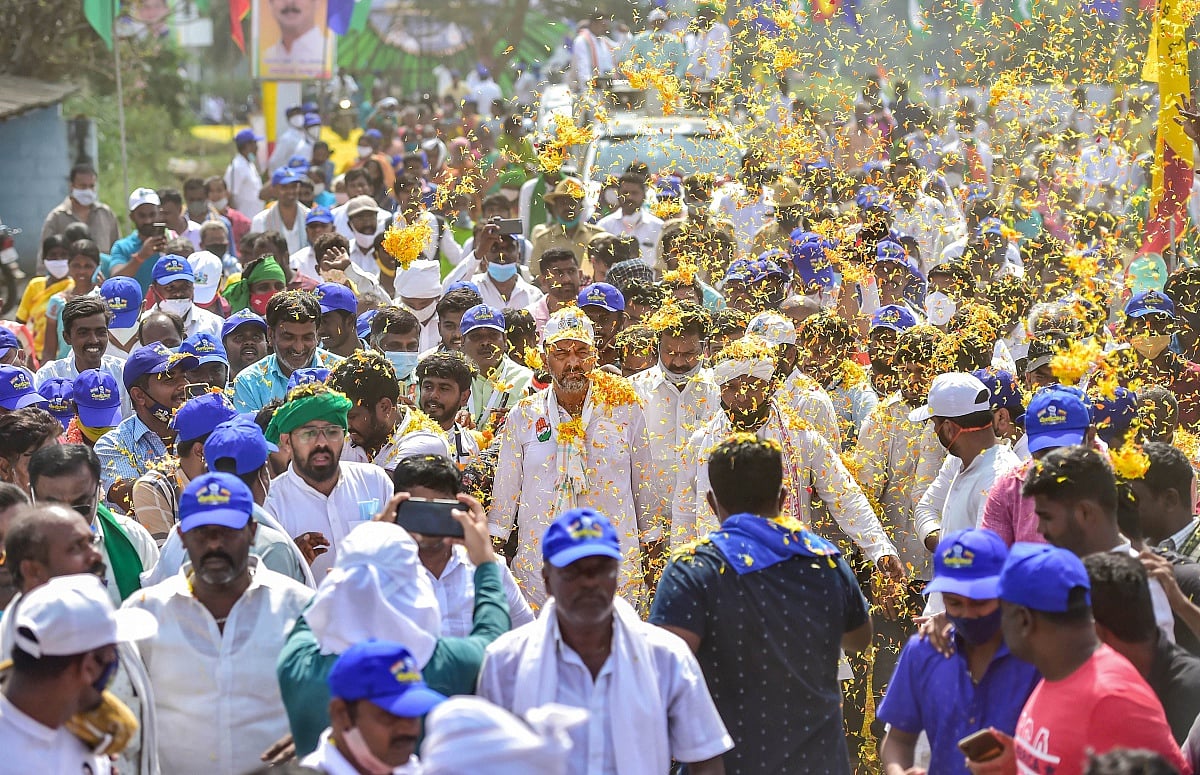  Supporters shower flower petals on KPCC President D K Shivakumar as he walks with party workers, during the 2nd day of the 10-day padayatra from Mekedatu to Bengaluru to demand the implemention of Mekedatu project, in Dodda Alahalli near Bengaluru, Monday, Jan. 10, 2022 | Shailendra Bhojak