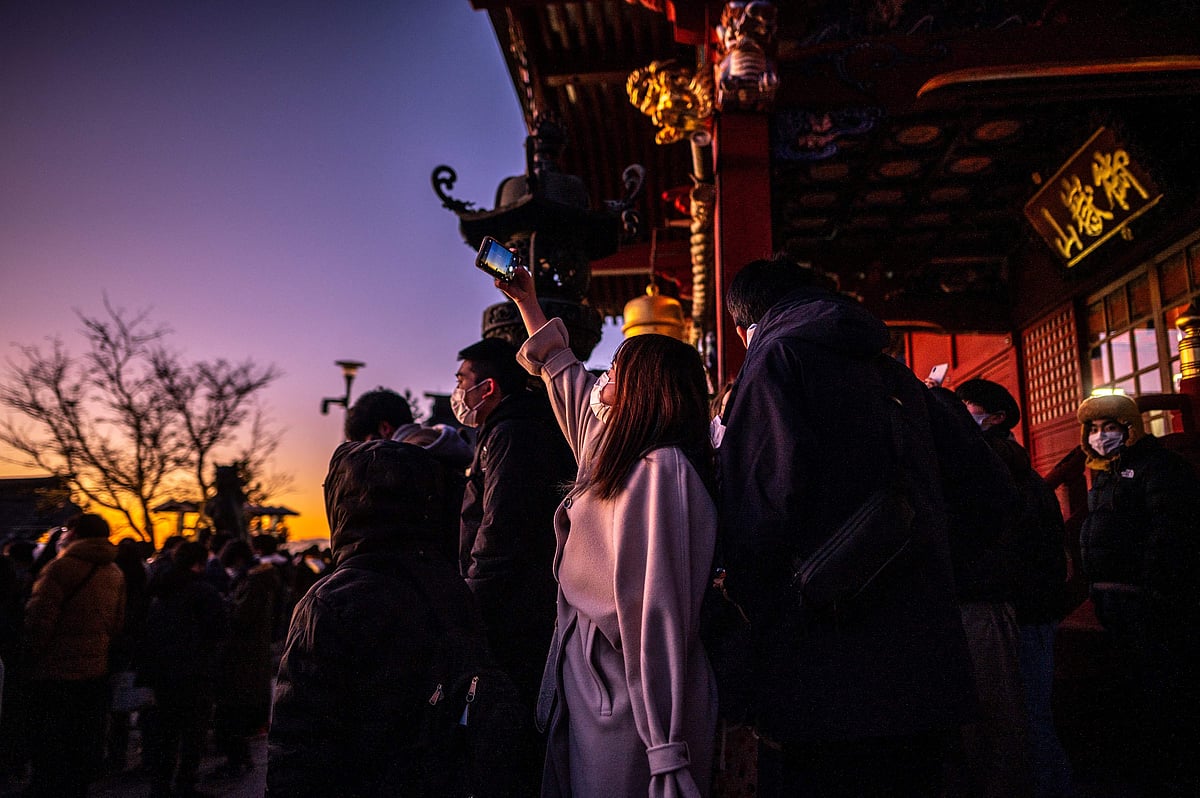 People gather to watch the sunrise on New Years Day at Musashi-Mitake Shrine in Ome city of Tokyo on January 1, 2022. 