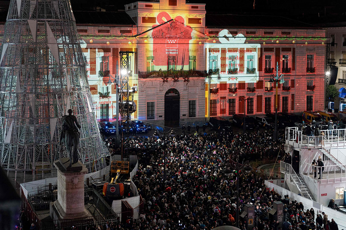 People celebrate New Years Eve on the Puerta Del Sol square in Madrid, on December 31, 2021. 