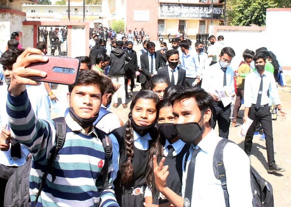 A student clicks a selfie while coming out of examination center in Bhopal on Monday