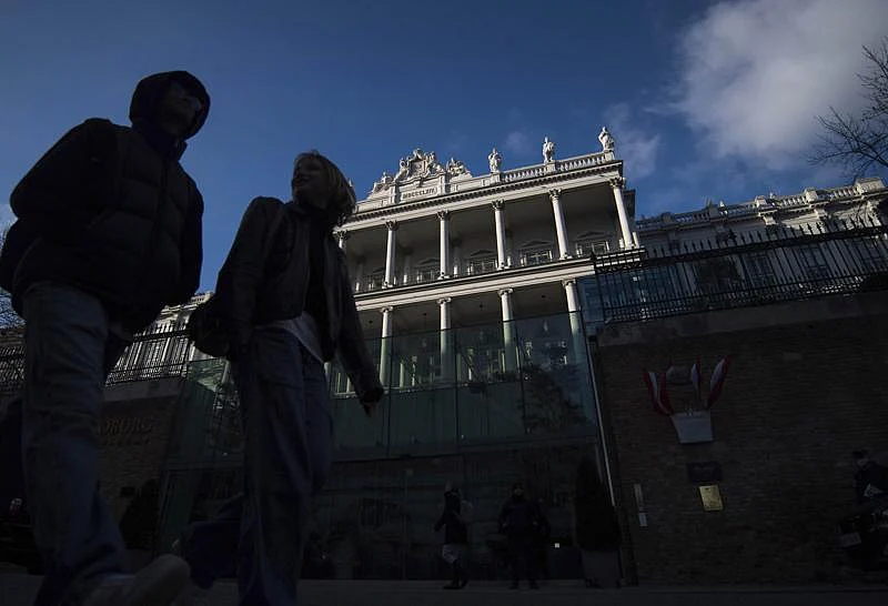 People walk past Palais Coburg, where closed-door nuclear talks take place in Vienna, Austria | AP