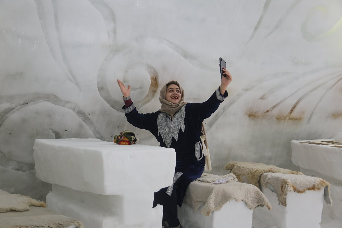 Visitor takes selfie inside World's biggest Igloo Cafe made of snow in Gulmarg, Kashmir.