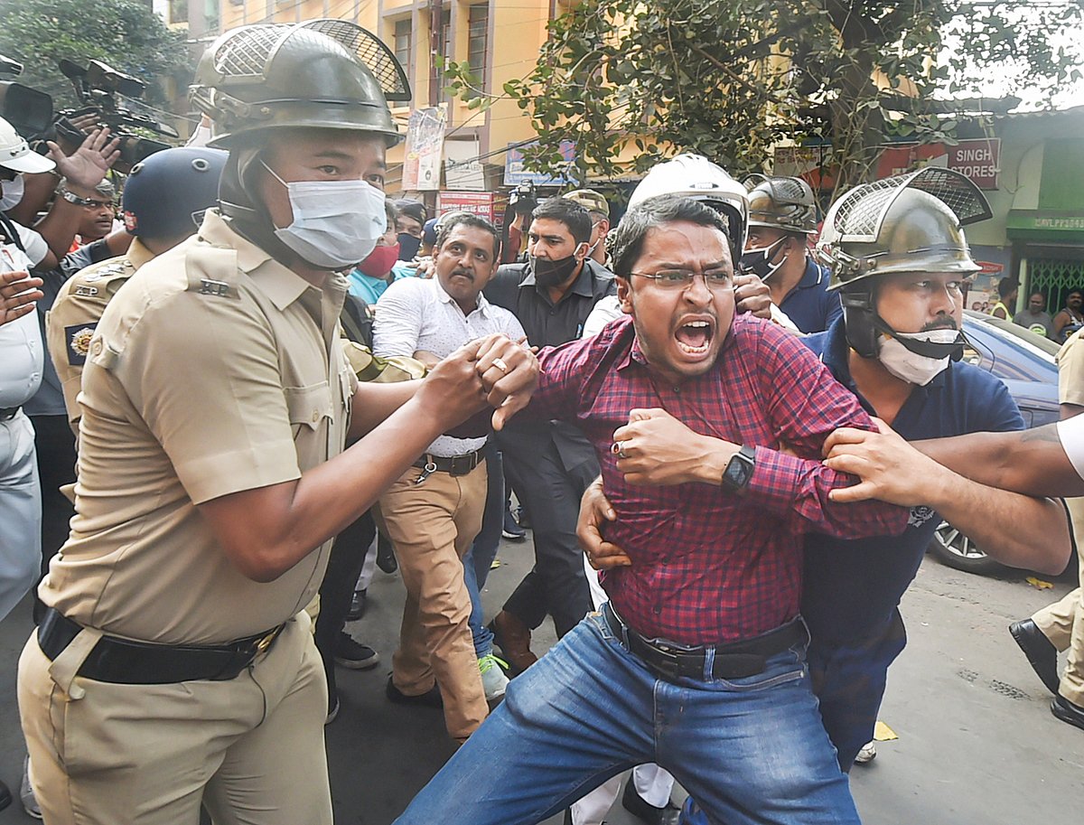Kolkata: Police detain an activist during BJP activists march towards Lalbazar (Kolkata Police headquarters) to protest against the alleged violence during the ongoing West Bengal Municipality polls, in Kolkata, Sunday, Feb. 27, 2022.