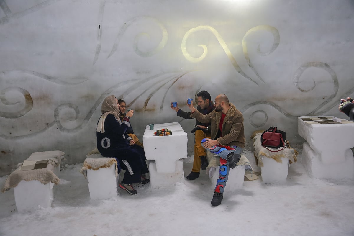 Visitors sit and have drinks inside World's biggest Igloo Cafe made of snow in Gulmarg, Kashmir.