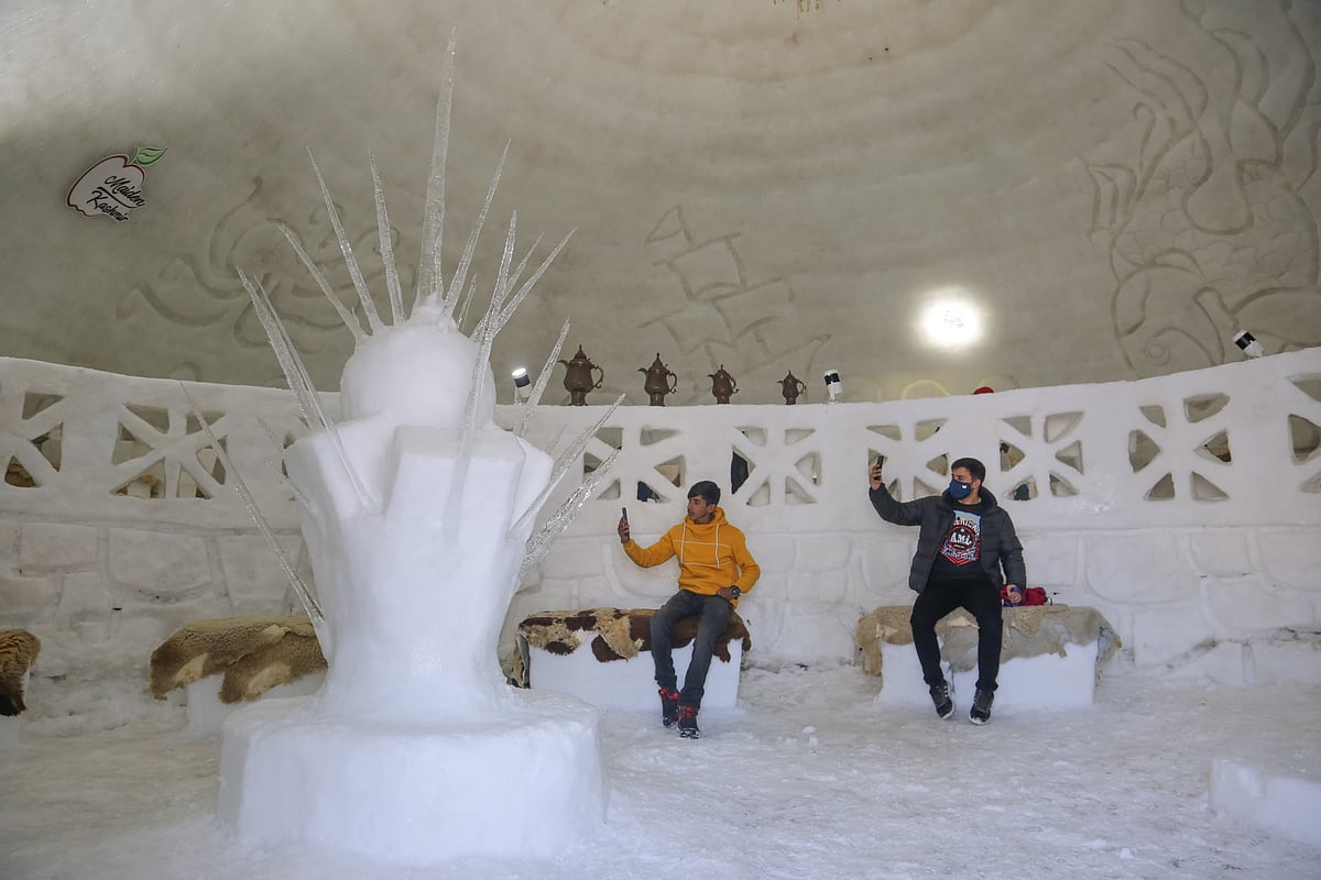 Visitor takes selfie inside World's biggest Igloo Cafe made of snow in Gulmarg, Kashmir.