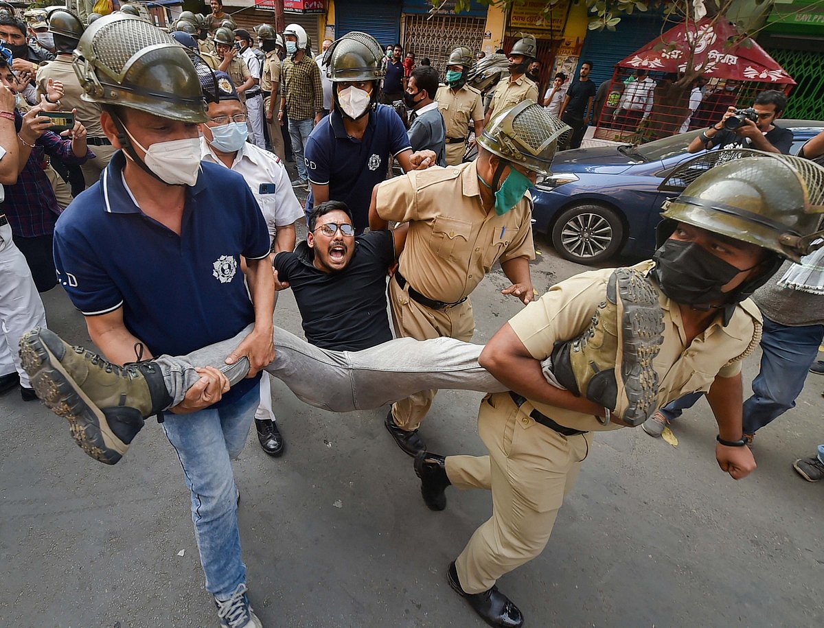 Kolkata: Police detain an activist during BJP activists march towards Lalbazar (Kolkata Police headquarters) to protest against the alleged violence during the ongoing West Bengal Municipality polls, in Kolkata, Sunday, Feb. 27, 2022.