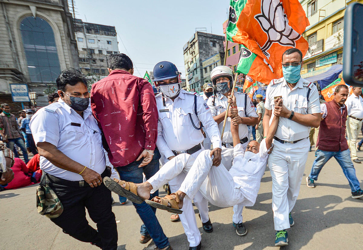 Howrah: Police detain BJP activists during their call for a 12-hour bandh in West Bengal to protest against alleged rigging and violence during civic polls, in Howrah district, Monday, Feb. 28, 2022.