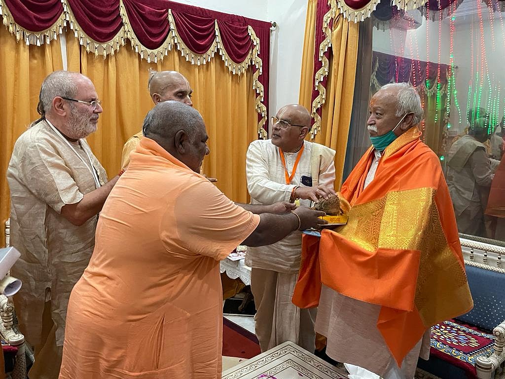 ISKCON functionaries present Prasad and books to the RSS chief. 