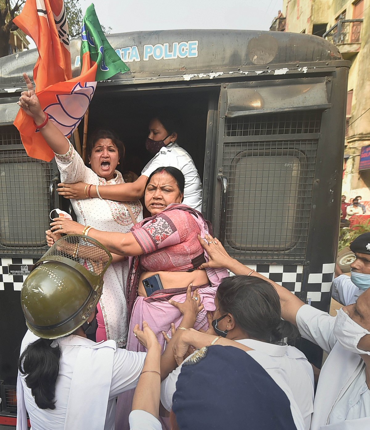 Kolkata: Police detain BJP activists during their march towards Lalbazar (Kolkata Police headquarters) to protest against the alleged violence during the ongoing West Bengal Municipality polls, in Kolkata, Sunday, Feb. 27, 2022.