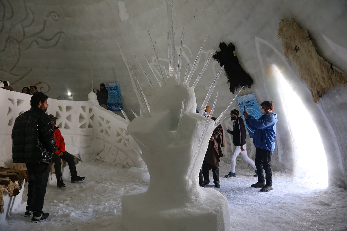 Visitors pose inside World's biggest igloo Café made of snow in Gulmarg, Kashmir