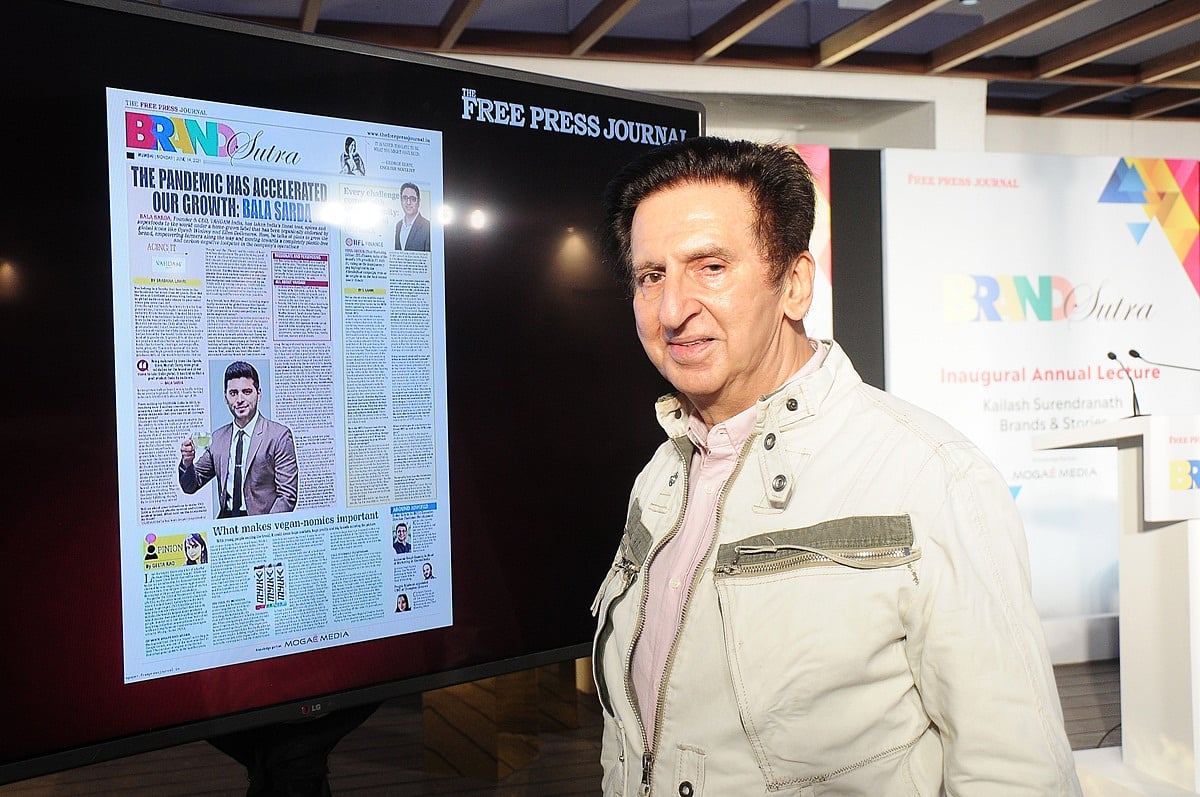Kailash Surendranath looking at BrandSutra pages on display at the event