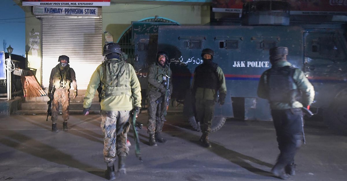 Security personnel stand guard near the site of a militant attack in Zewan, on the outskirts of Srinanagar | PTI