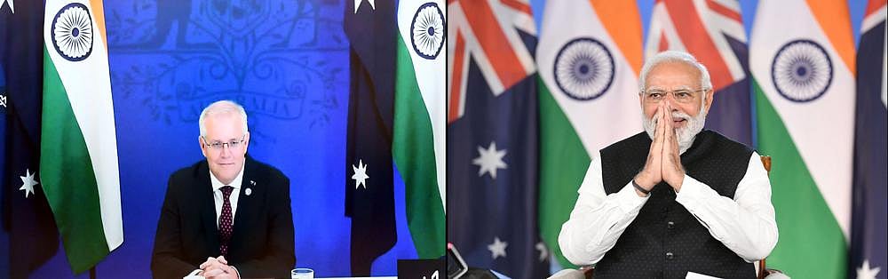 This combination photograph released by India's Press Information Bureau shows Australian Prime Minister Scott Morrison, left and Indian Prime Minister Narendra Modi holding a virtual summit, on March 21, 2022 | AP