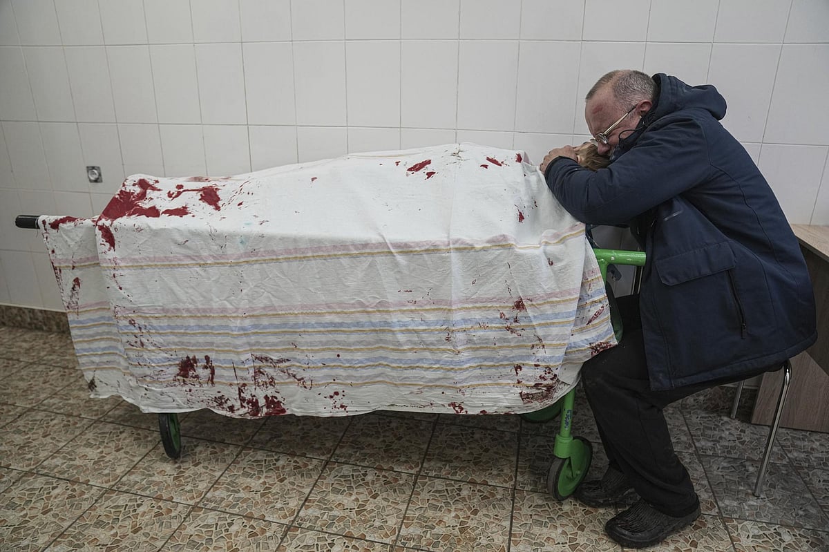 Serhii, father of teenager Iliya, cries on his son's lifeless body lying on a stretcher at a maternity hospital converted into a medical ward in Mariupol, Ukraine, on March 2, 2022 | AP
