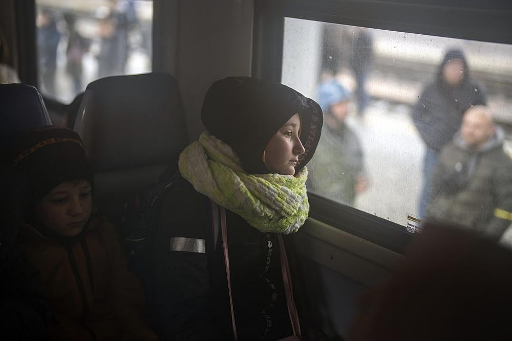 A girl and her brother sit on a train bound for Lviv at the Kyiv station, Ukraine, on Thursday