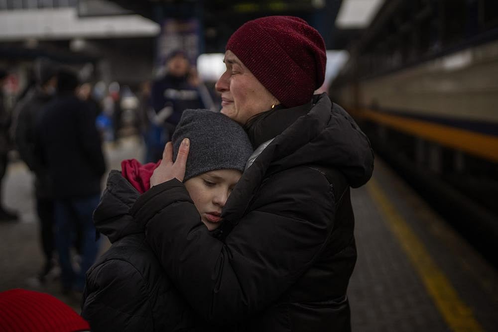 Tanya, 38, cries with her son Bogdan, 10, before getting a train to Lviv at the Kyiv station, Ukraine, on Thursday
