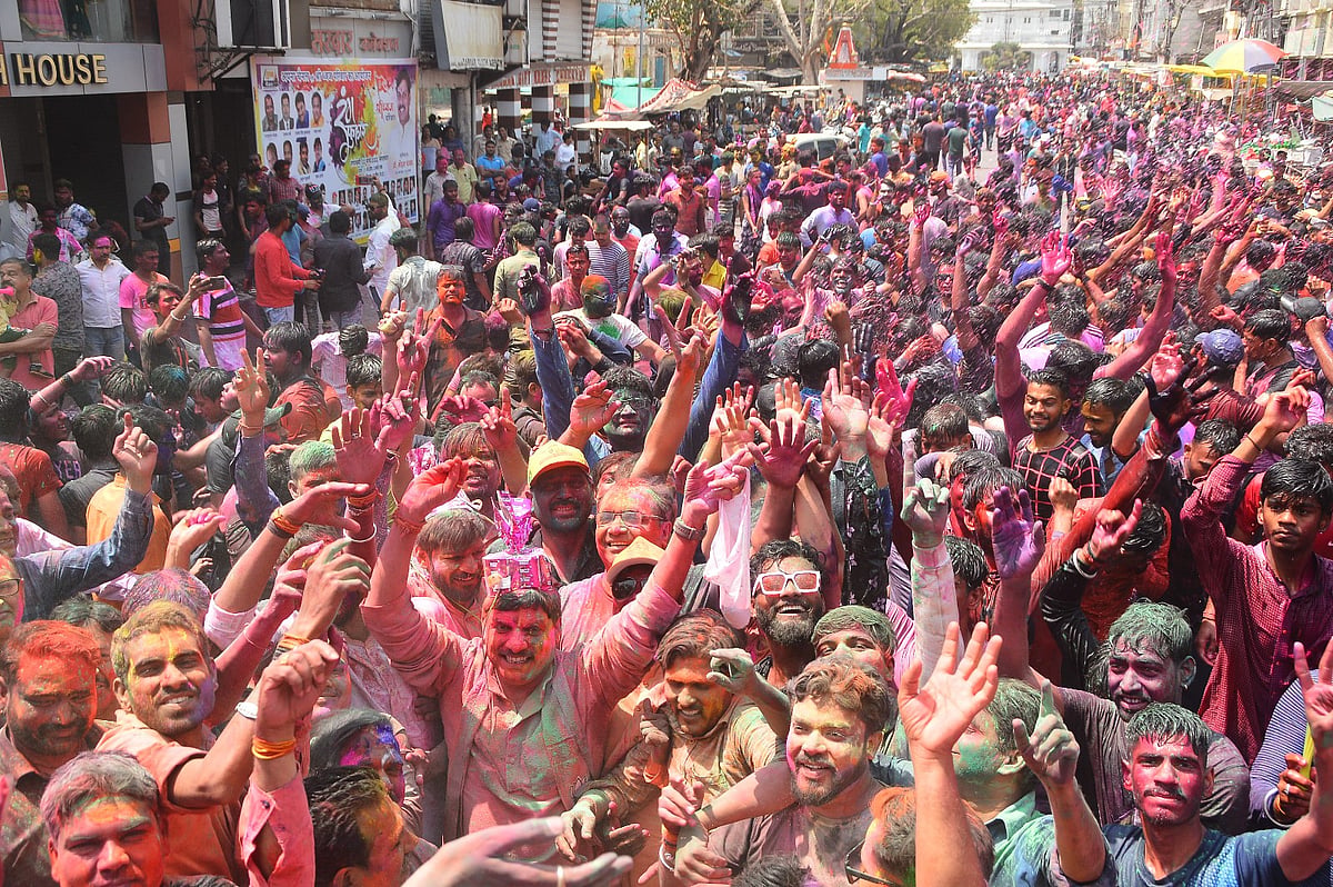 Higher Education Minister Mohan Yadav surrounded by hundreds of people play the festival of colours at Shaheed Park.