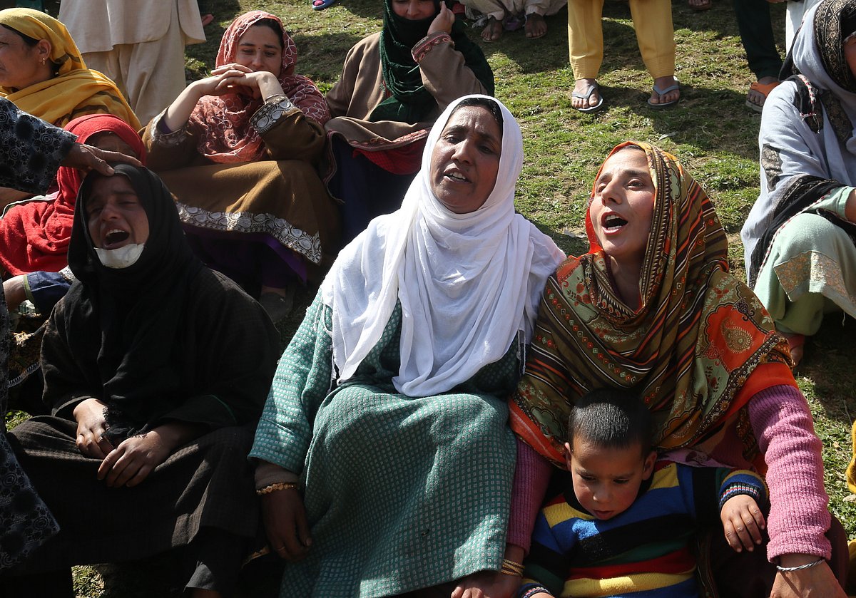 Relatives mourn at the funeral of slain policeman and his brother at Chattabugh village of central Kashmir's Budgam district