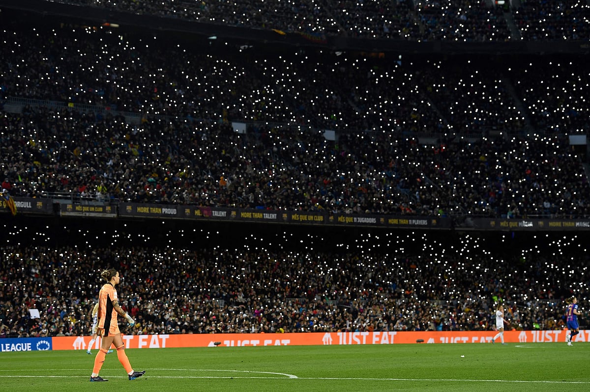 Fans use their flashlight during the match