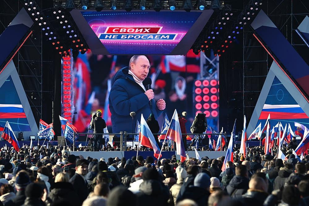 Russian President Vladimir Putin seen on the big screen as he delivers his speech at the concert marking the eighth anniversary of the referendum on the state status of Crimea and Sevastopol and its reunification with Russia, in Moscow, Russia, on Friday | AP