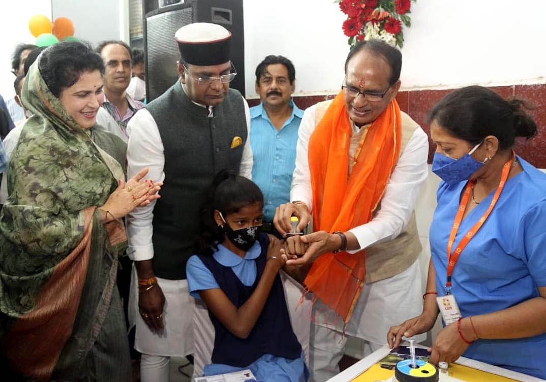 CM Shivraj Singh Chouhan , minister 
Vishvas Sarang at a vaccination centre, in Bhopal, Wednesday.